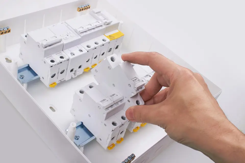 Safety switch components being fitted to an electrical panel