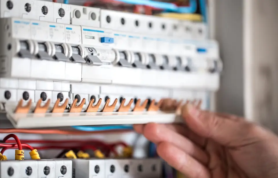Modern circuit breakers and wiring inside an electrical switchboard
